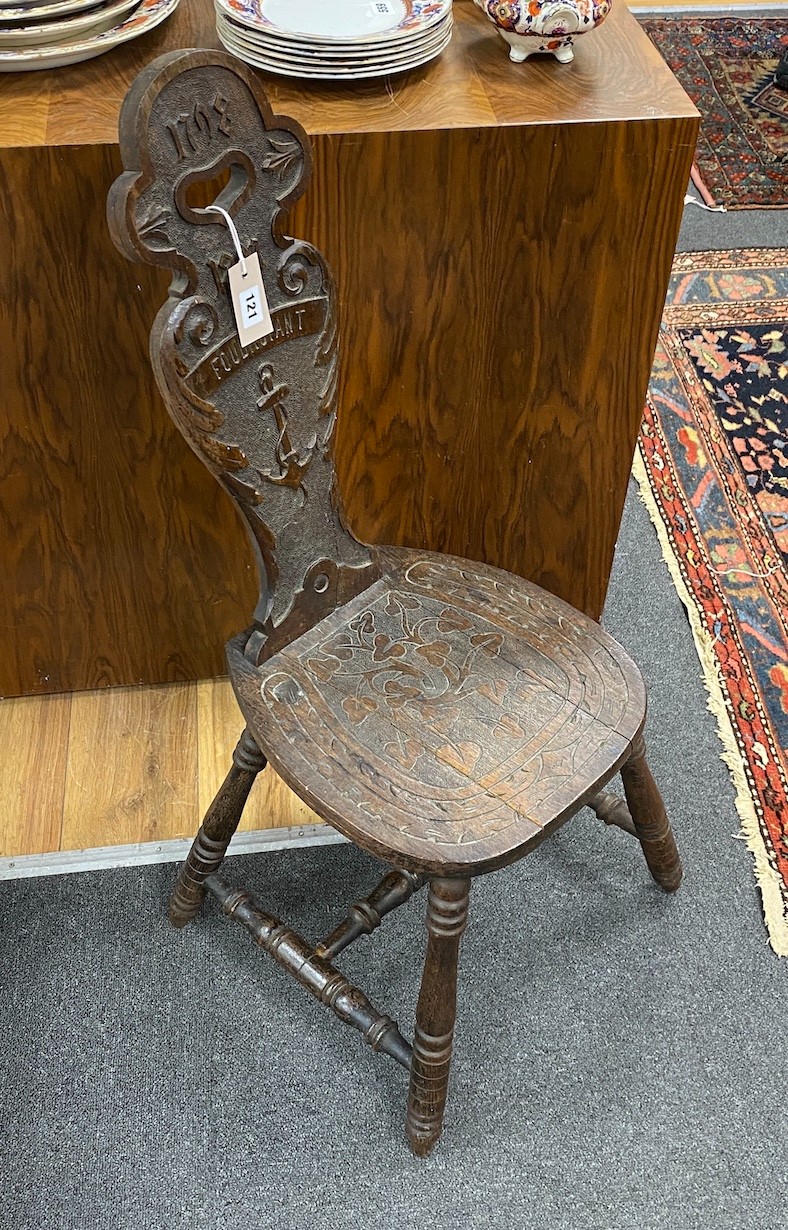 A Victorian carved oak spinning chair, by repute made from the timbers of HMS Foudroyant, dated 1897, height 88cm